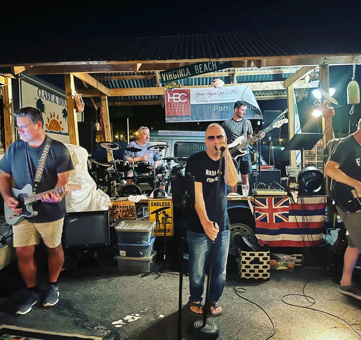 The band playing the outdoor stage at Clare and Don's Beach Shack at night